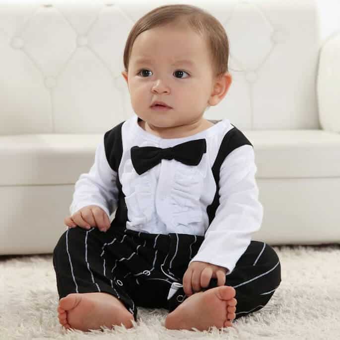 Newborn baby wearing white formal suit and tie