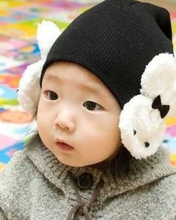 Black handmade winter hat for newborn baby, soft knitted design for warmth and comfort