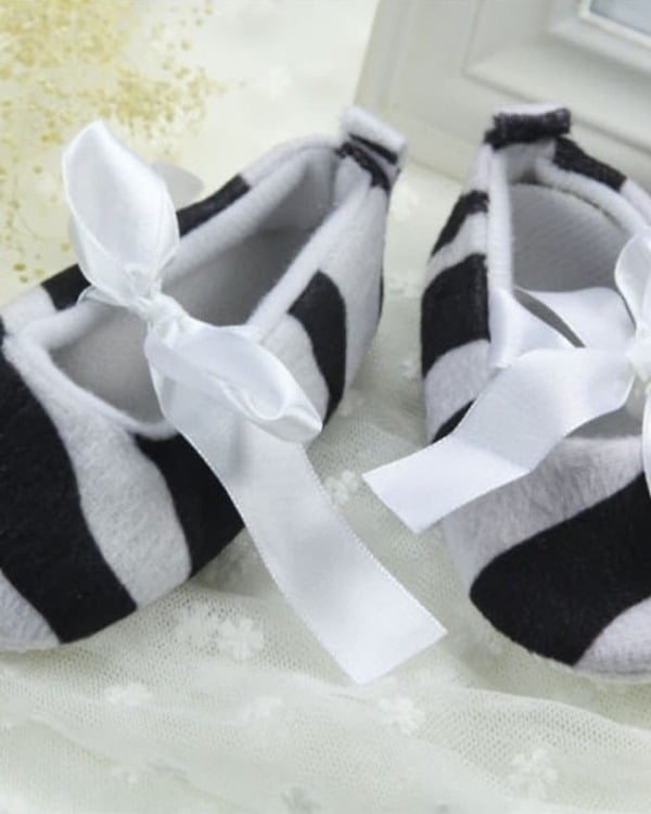 Baby girl shoes in grey and black stripes, stylish and festive for celebrations
