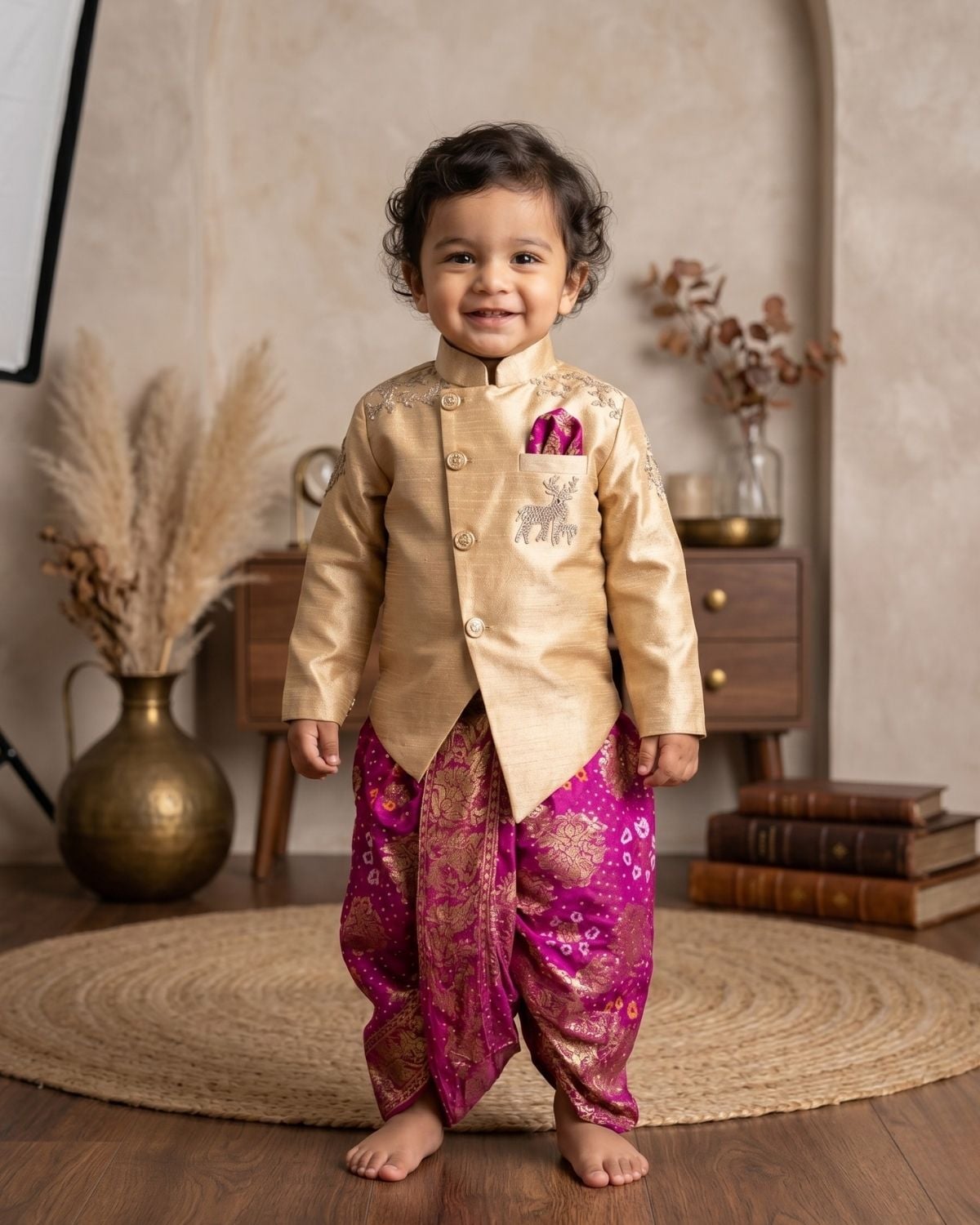 Boys gold silk sherwani with silver deer embroidery and magenta banarasi dhoti set for Indian wedding