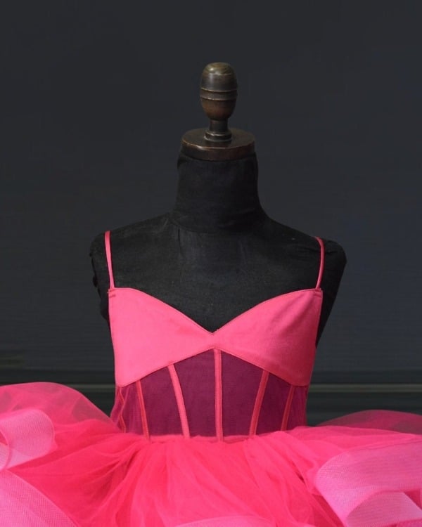 Close-up of hot pink structured sweetheart bodice with spaghetti straps on dress mannequin for birthday party